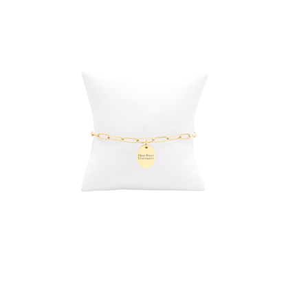 High Point University gold link storyline bracelet with small oval charm with high point university horizontal text on white pillow front view
