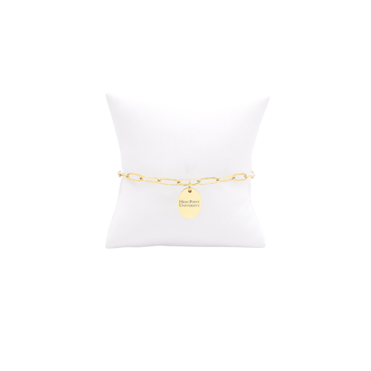 High Point University gold link storyline bracelet with small oval charm with high point university horizontal text on white pillow front view
