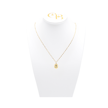 High Point University gold twist necklace with small oval charm with high point university text and panther logo on white pillow front view
