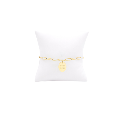 Sigma Sigma Sigma gold link storyline bracelet with small oval charm with full sorority name on white pillow front view