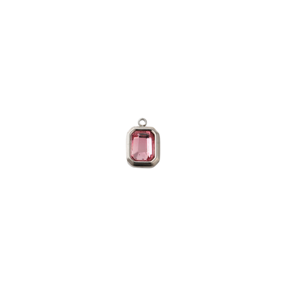 Silver rectangular charm featuring a faceted flamingo pink gemstone on a white background