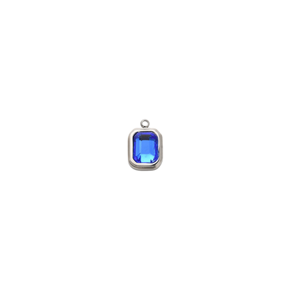 Silver rectangular charm featuring a faceted navy blue gemstone on a white background.