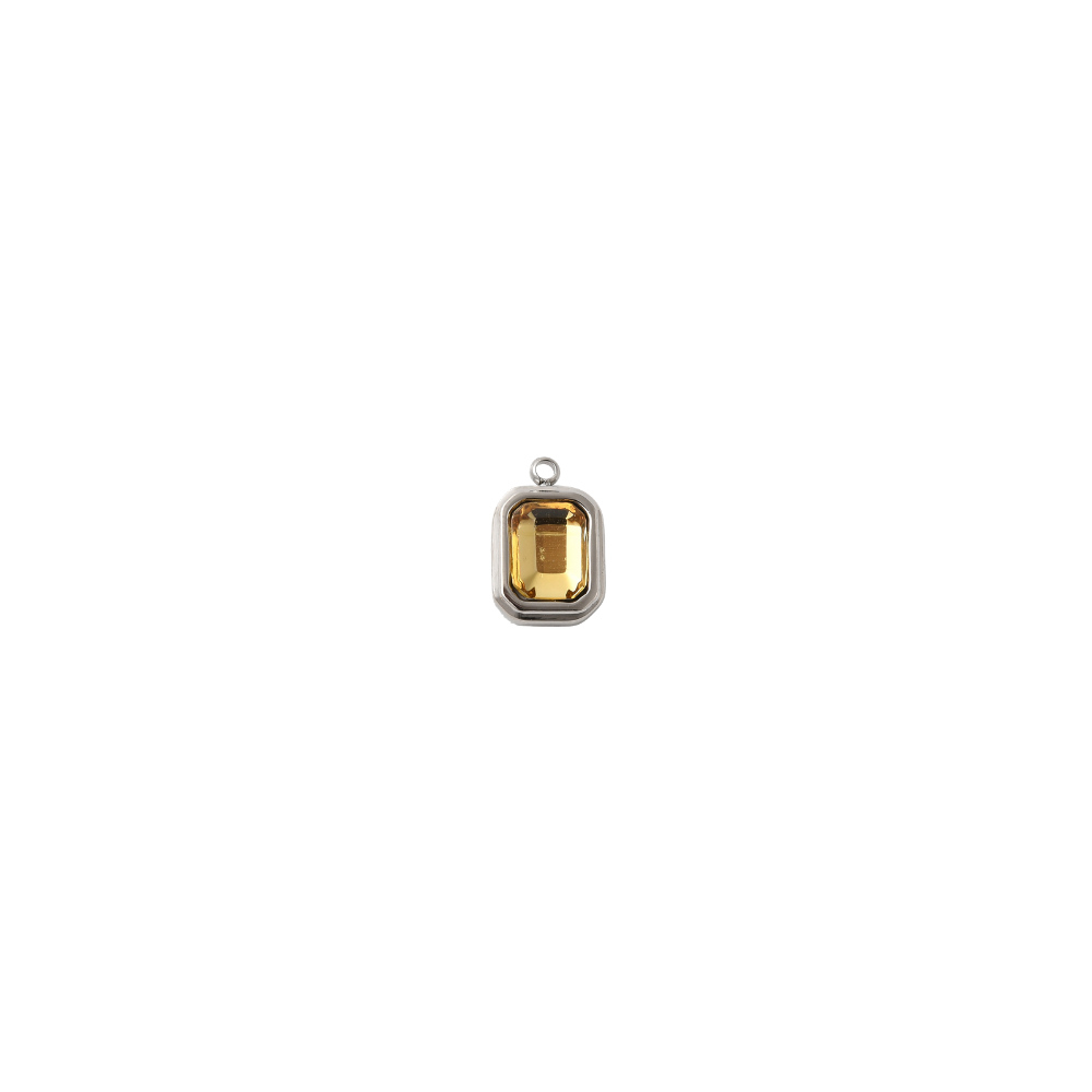 Silver rectangular charm featuring a faceted topaz gemstone on a white background.