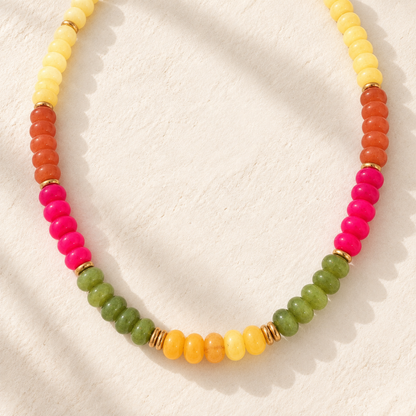 The Cactus Bloom Beaded Necklace featuring yellow, orange, hot pink, and green beads with polished gold-tone spacer accents.
