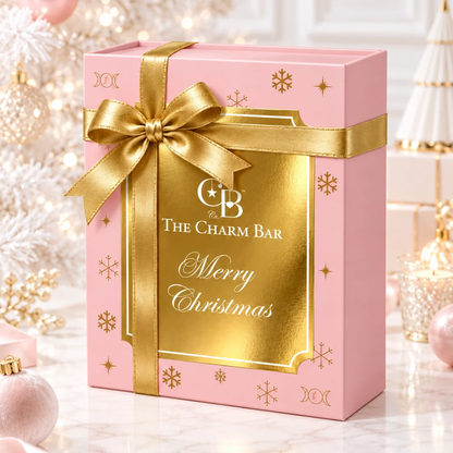 The Charm Bar Company limited edition Heirloom Advent Calendar in an elegant pink and gold Christmas gift box with gold ribbon and festive holiday decorations.