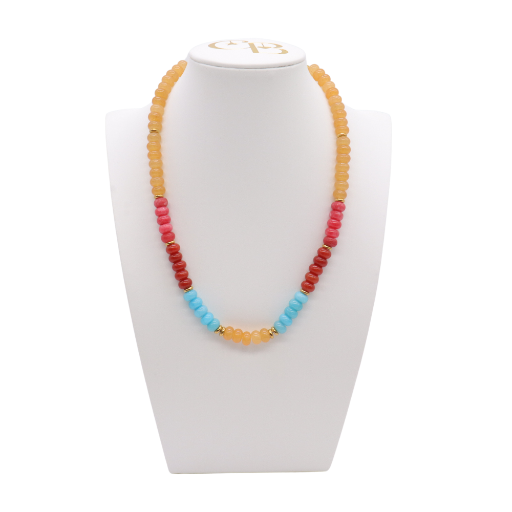 Desert Sky Beaded Necklace featuring peach, coral, deep red, and turquoise blue beads with polished gold-tone spacer accents.