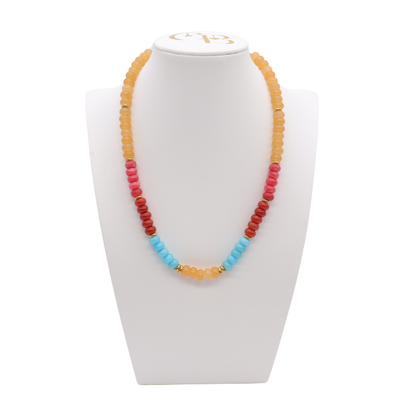 Desert Sky Beaded Necklace featuring peach, coral, deep red, and turquoise blue beads with polished gold-tone spacer accents.