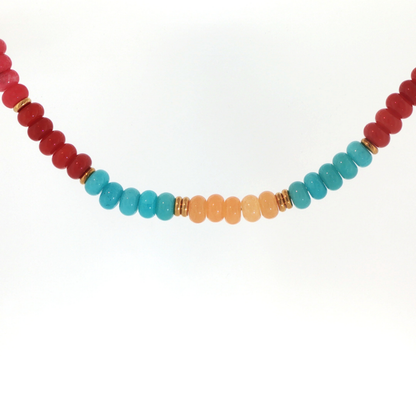 Desert Sky Beaded Necklace featuring peach, coral, deep red, and turquoise blue beads with polished gold-tone spacer accents.