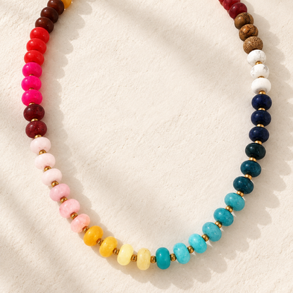 Wildflower Beaded Necklace featuring multicolor turquoise, blue, pink, red, yellow, cream, and brown beads with subtle gold-tone spacer accents.