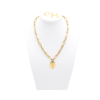 Theta Phi Alpha gold large link keepsake necklace with large oval charm displayed on white necklace bust front view with vertical/stacked greek letters