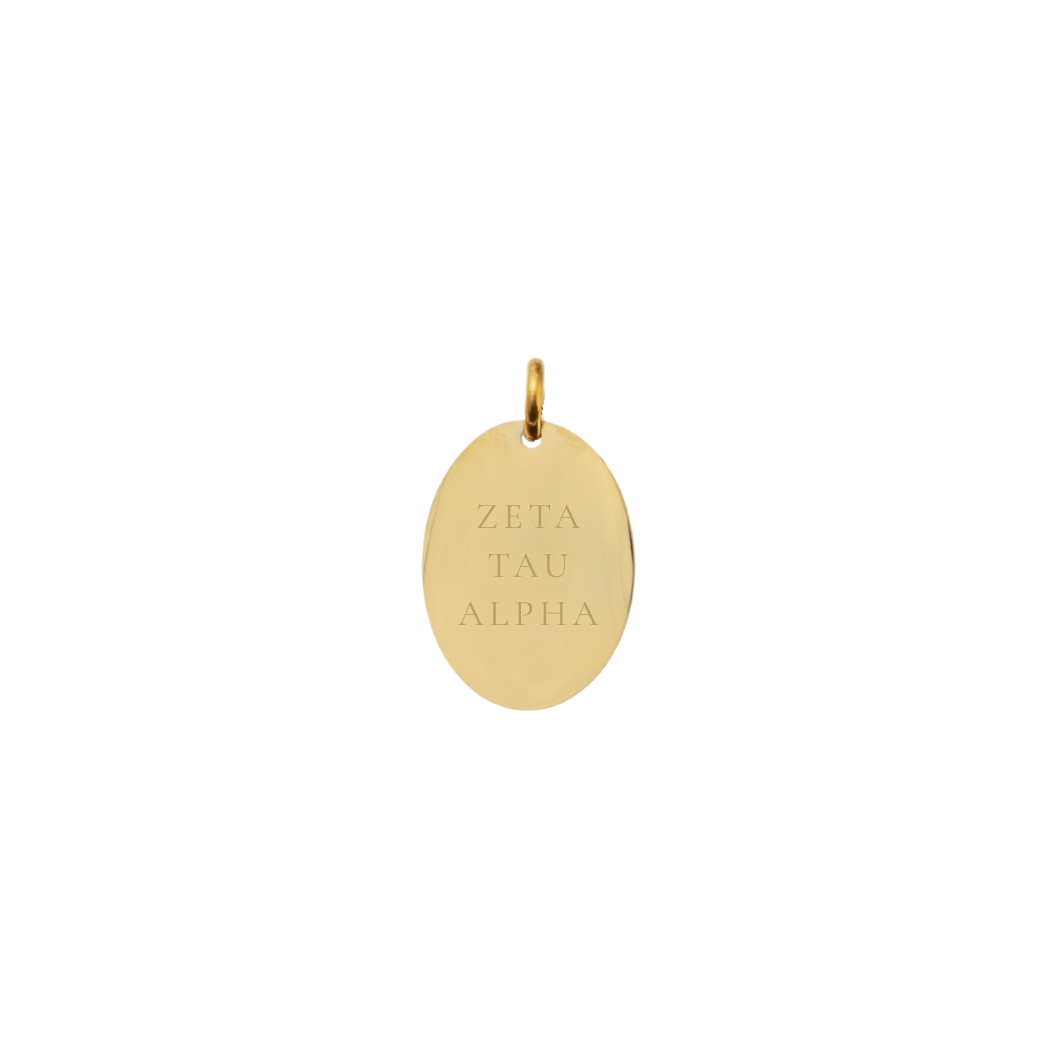 Zeta Tau Alpha gold small oval charm with full sorority name front view.
