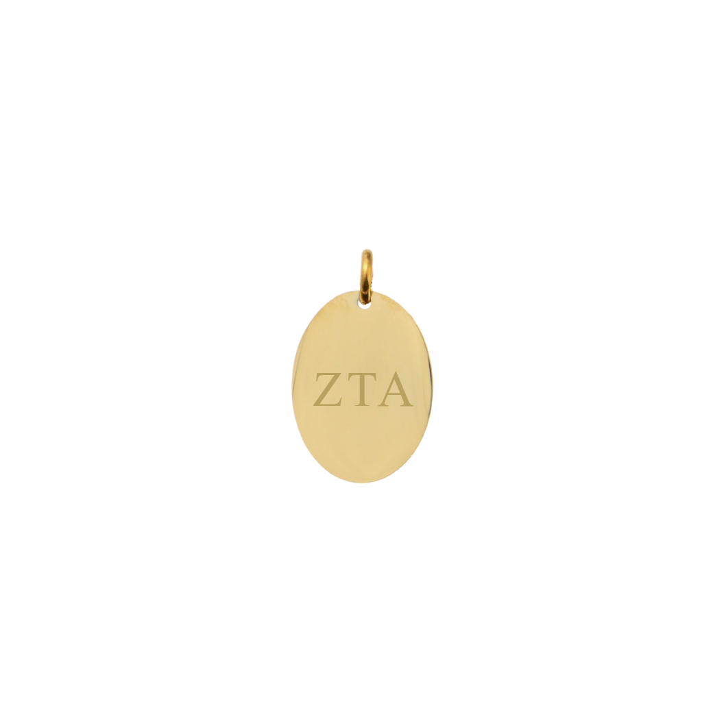 Zeta Tau Alpha gold small oval charm with horizontal greek letters front view.